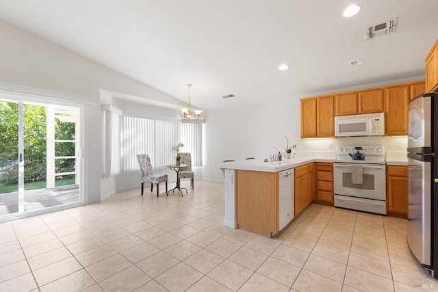 kitchen with light tile patterned floors, a peninsula, white appliances, and visible vents