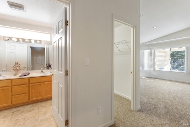 full bath with double vanity, baseboards, visible vents, tile patterned floors, and a sink