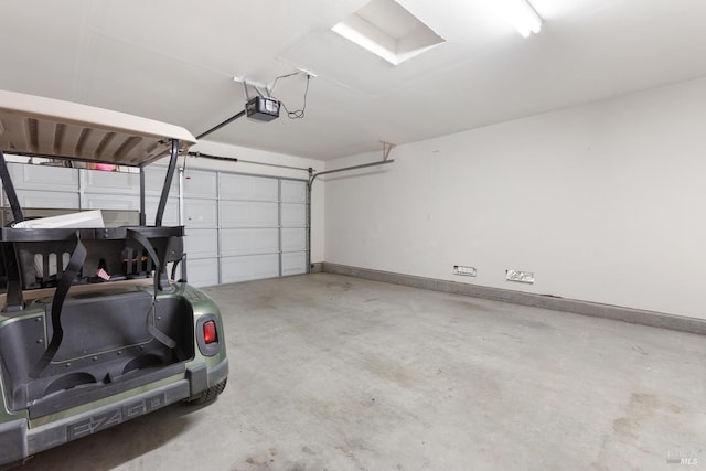 garage with baseboards and a garage door opener