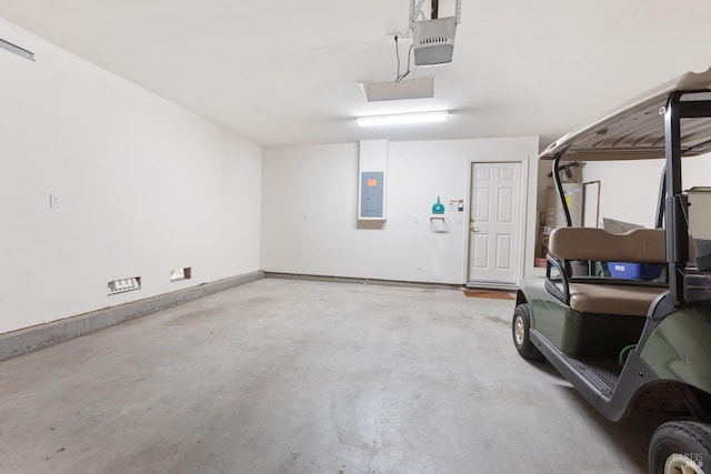 garage featuring baseboards, gas water heater, electric panel, and a garage door opener