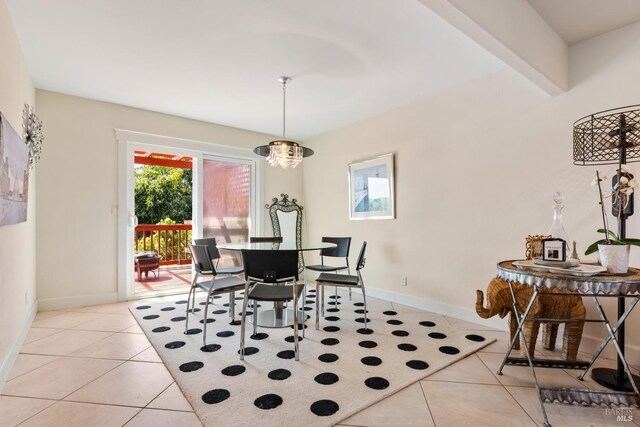 dining area with beam ceiling and light tile patterned flooring