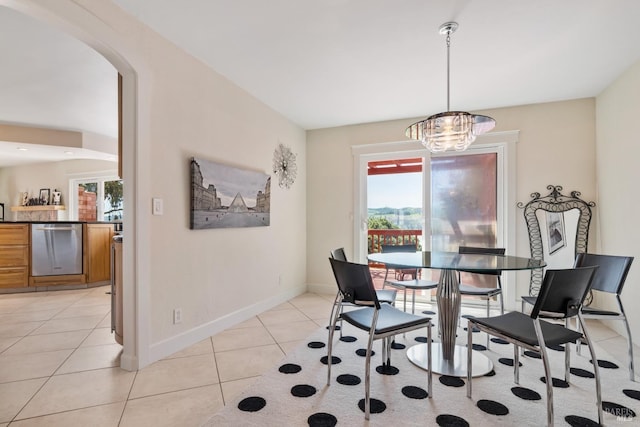 tiled dining space with a wealth of natural light and a chandelier