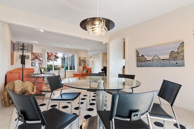 dining area featuring a chandelier and light tile patterned floors