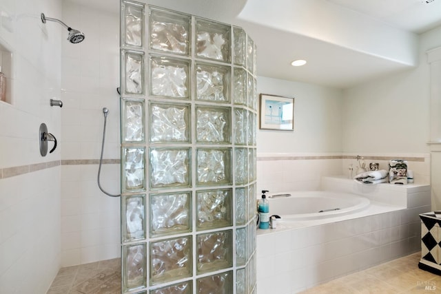 bathroom featuring tile walls, independent shower and bath, and tile patterned floors