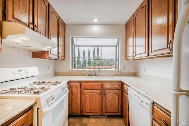 kitchen with light tile patterned floors, white appliances, and sink