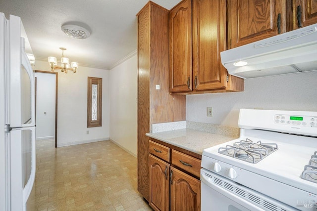 kitchen with white appliances, hanging light fixtures, an inviting chandelier, and ornamental molding