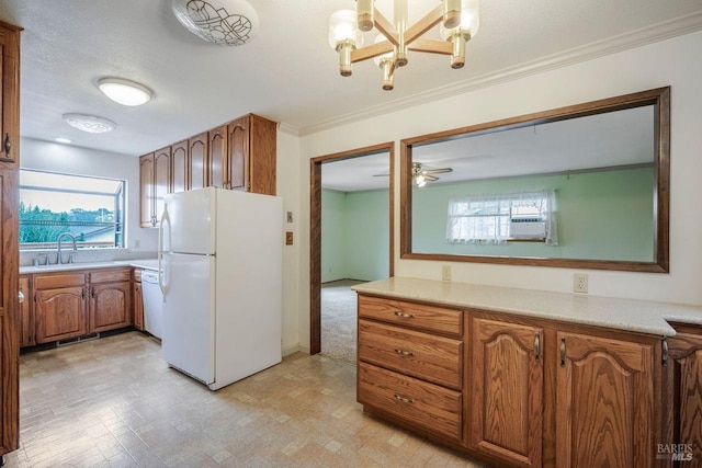 kitchen featuring a textured ceiling, ceiling fan with notable chandelier, white appliances, crown molding, and sink