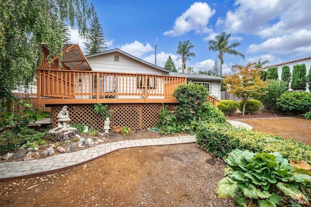 rear view of property with a wooden deck