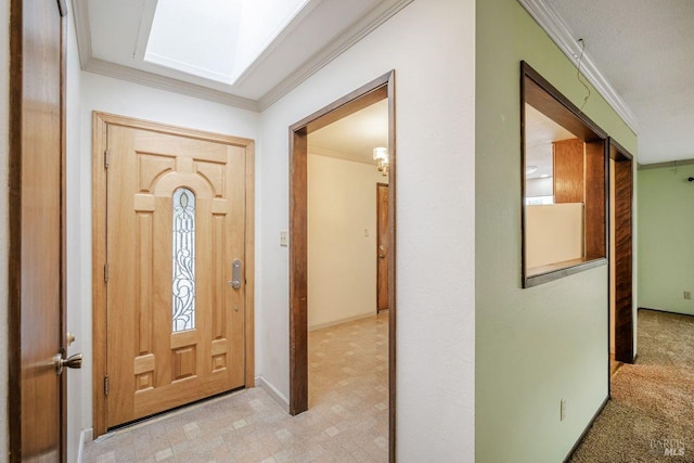 carpeted foyer entrance featuring ornamental molding and a skylight