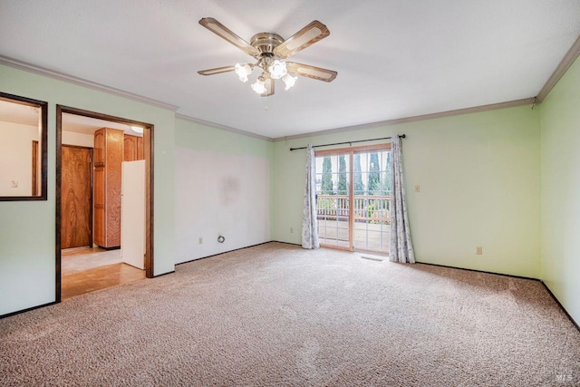 empty room with ceiling fan, light colored carpet, and crown molding