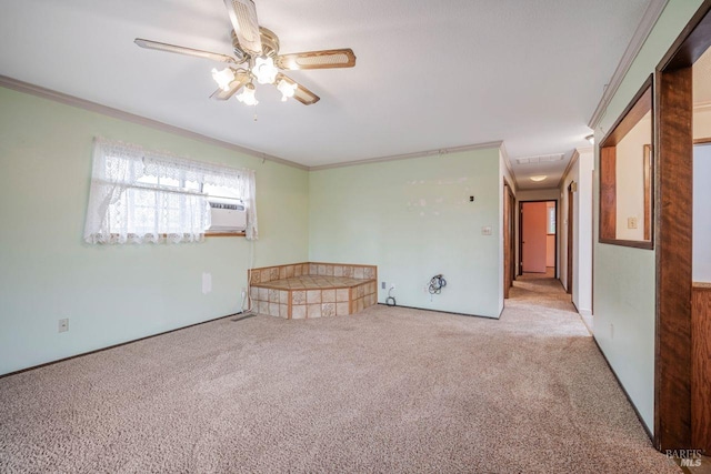 carpeted spare room featuring ceiling fan and ornamental molding