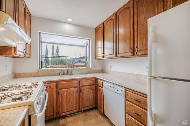 kitchen with sink, white appliances, and extractor fan