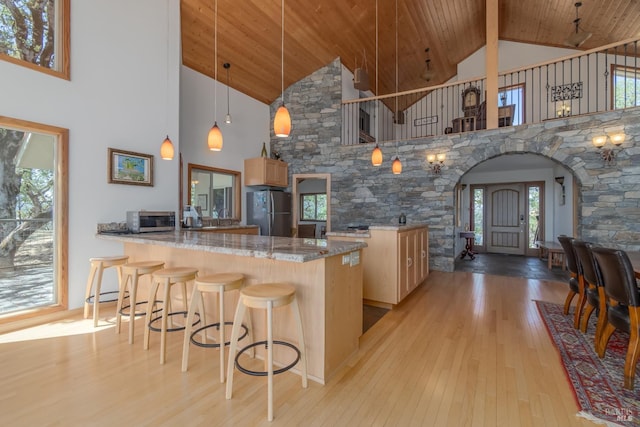 1280 W State Highway 20th St, Upper Lake, CA 95485 - kitchen featuring a peninsula, appliances with stainless steel finishes, arched walkways, light wood-style floors, and wood ceiling