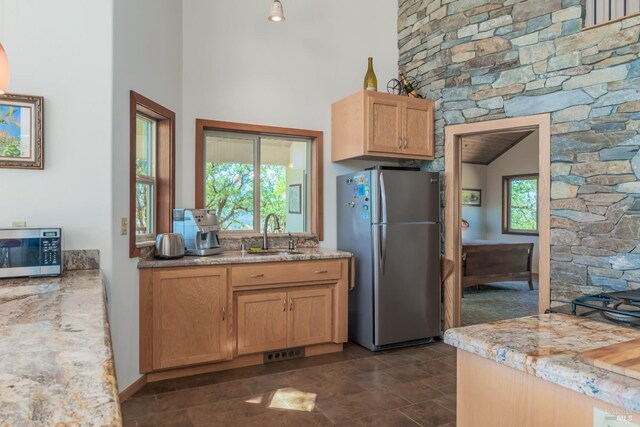 1280 W State Highway 20th St, Upper Lake, CA 95485 - kitchen featuring a sink, a towering ceiling, visible vents, light stone countertops, and appliances with stainless steel finishes