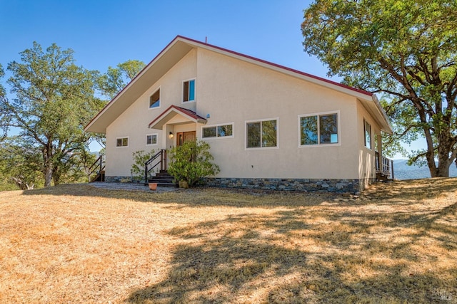 1280 W State Highway 20th St, Upper Lake, CA 95485 - rear view of house with stucco siding and a lawn
