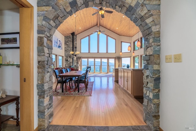 1280 W State Highway 20th St, Upper Lake, CA 95485 - dining area with high vaulted ceiling, wooden ceiling, wood-type flooring, ceiling fan with notable chandelier, and arched walkways