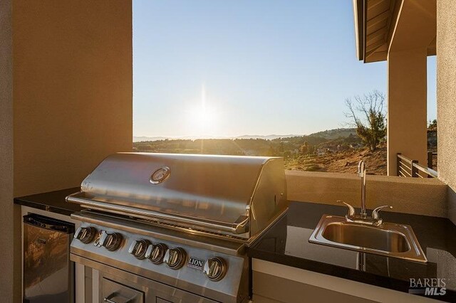 exterior space featuring stainless steel refrigerator and sink