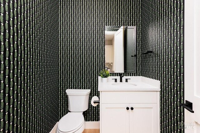 bathroom featuring vanity and toilet