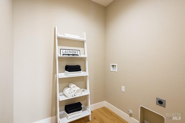 washroom featuring hookup for a washing machine, hookup for a gas dryer, electric dryer hookup, and wood-type flooring