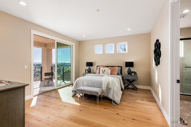 bedroom with access to outside and light hardwood / wood-style flooring