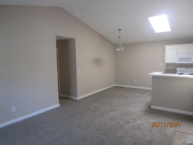 unfurnished living room featuring vaulted ceiling with skylight and light colored carpet