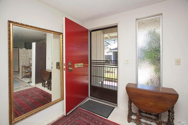 entryway featuring a textured ceiling