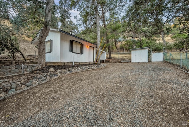 view of property exterior with a shed