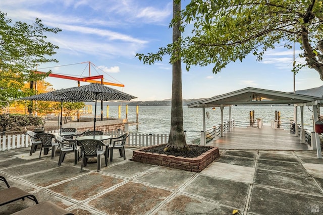 view of patio / terrace with a boat dock and a water view