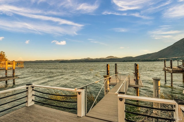 view of dock featuring a water and mountain view