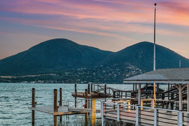 view of dock featuring a water and mountain view