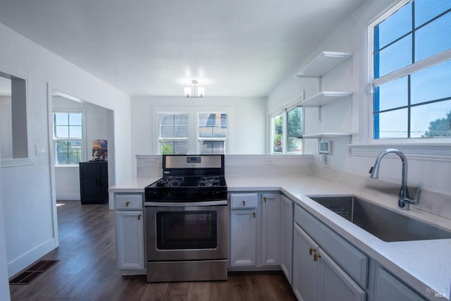 kitchen featuring a wealth of natural light, stainless steel range with gas cooktop, dark hardwood / wood-style floors, and sink