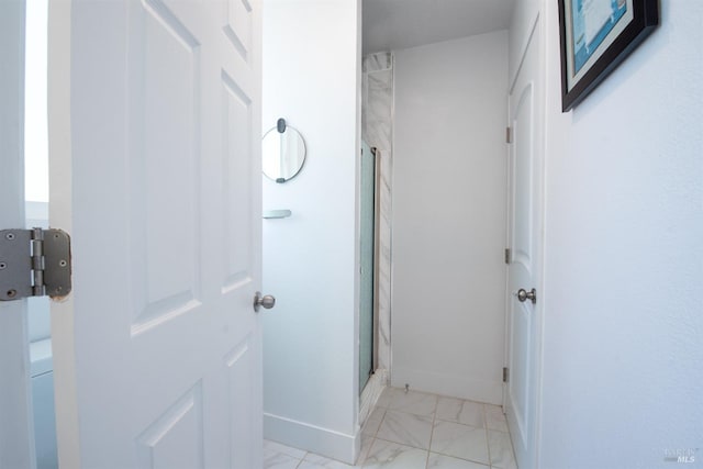 bathroom with a shower with door