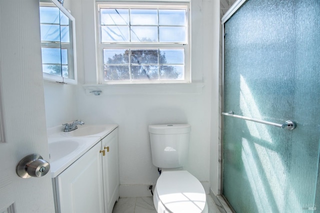 bathroom with vanity, toilet, and an enclosed shower