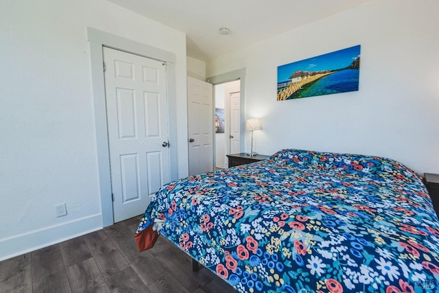 bedroom with dark hardwood / wood-style floors