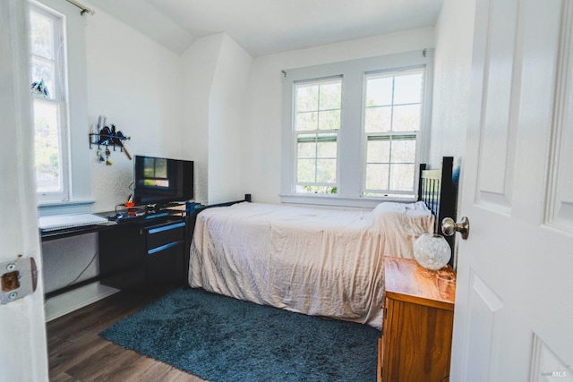 bedroom with dark wood-type flooring