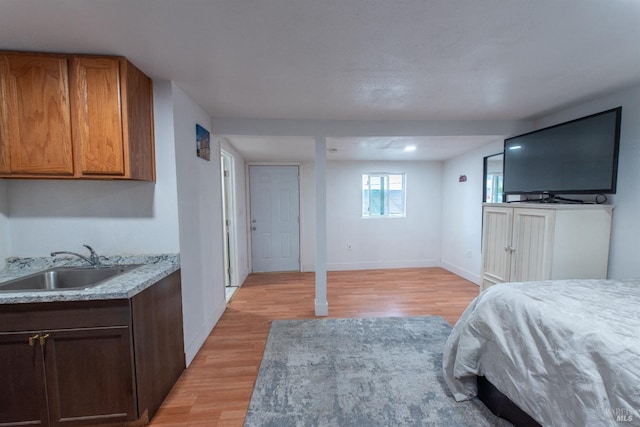 bedroom featuring sink and light hardwood / wood-style flooring