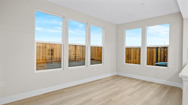 empty room with light hardwood / wood-style floors