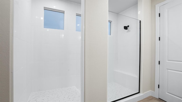 bathroom featuring tiled shower and hardwood / wood-style floors