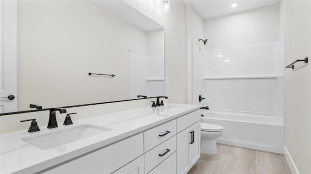 full bathroom with toilet, hardwood / wood-style flooring, shower / bath combination, and vanity