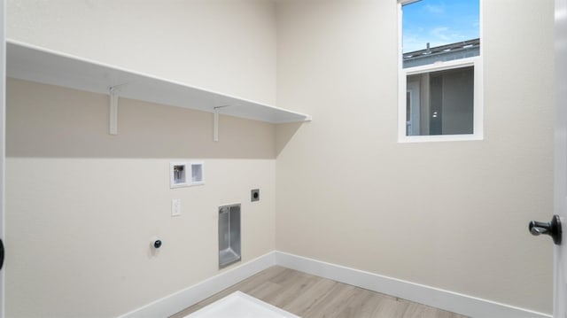 laundry area featuring hookup for a washing machine, light hardwood / wood-style floors, and electric dryer hookup