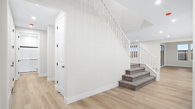 stairway featuring wood-type flooring