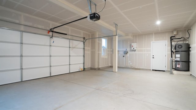 garage featuring secured water heater and a garage door opener