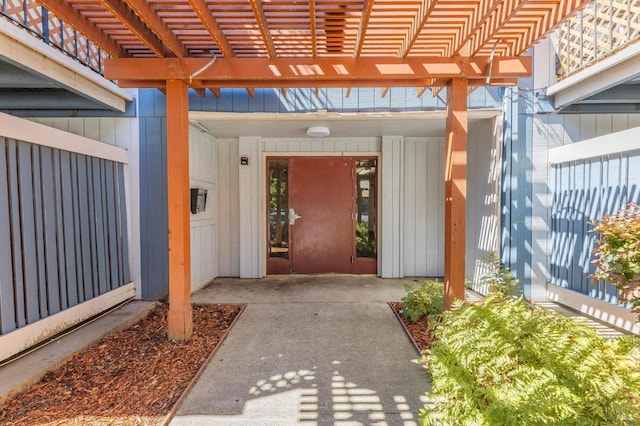 entrance to property with a patio and a pergola