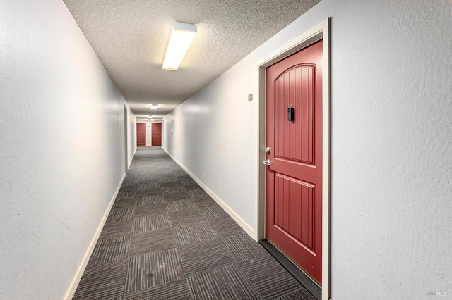 corridor featuring a textured ceiling