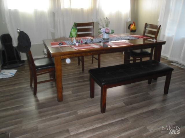 dining area with dark hardwood / wood-style flooring