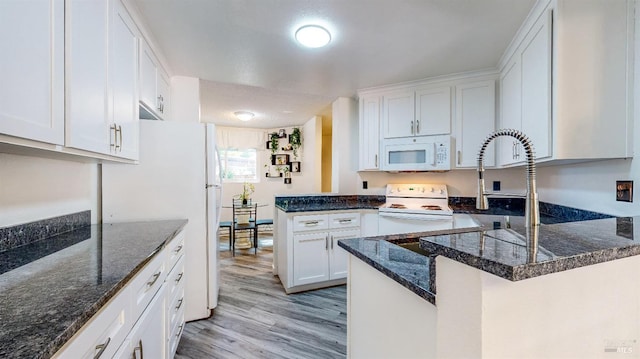 kitchen featuring white cabinets, white appliances, kitchen peninsula, and light hardwood / wood-style flooring