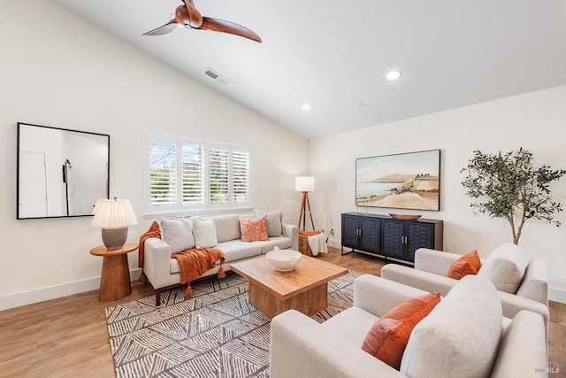 living room featuring ceiling fan, high vaulted ceiling, and light hardwood / wood-style floors