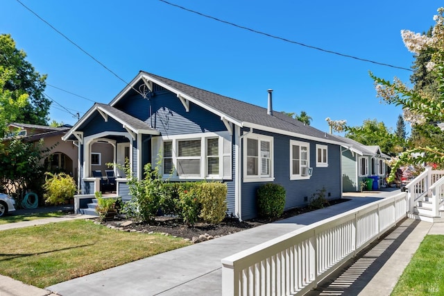 view of side of property featuring cooling unit, a porch, and a lawn