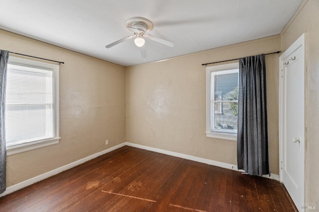 empty room with ceiling fan and dark hardwood / wood-style flooring