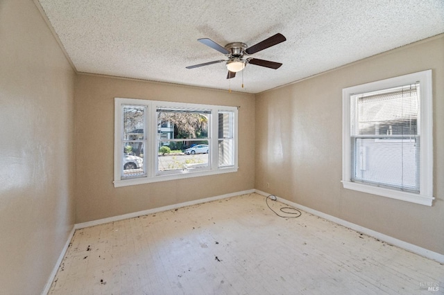 spare room with ceiling fan and a textured ceiling